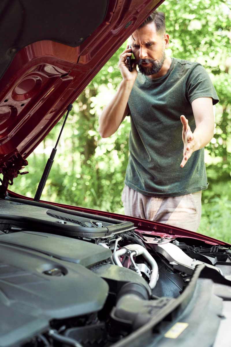 Junger Mann prüft Getriebeschaden bei Schrottauto Ankauf Wuppertal